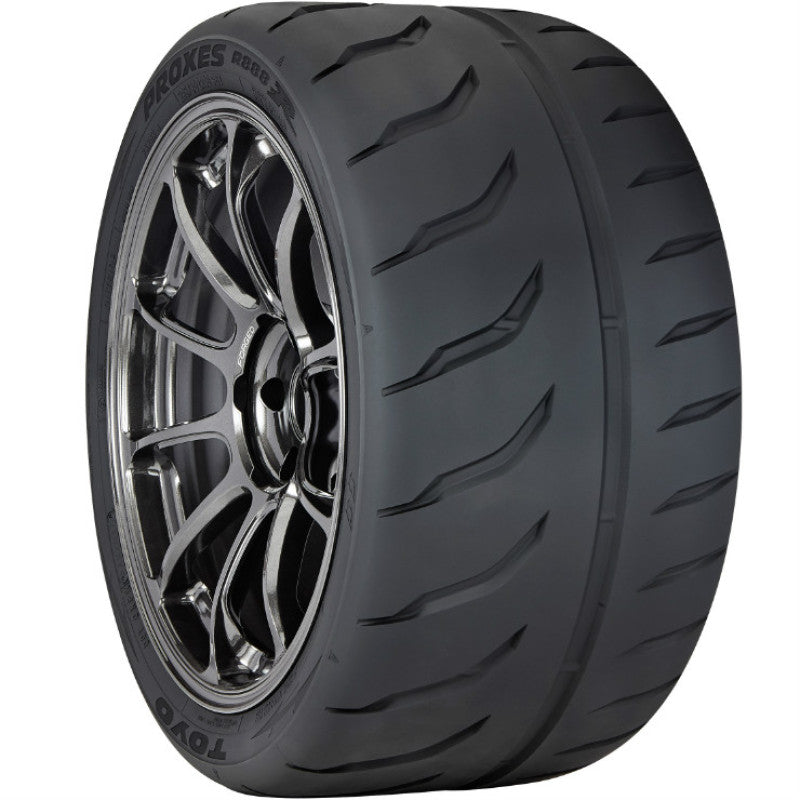 The Toyo Proxes R888R Tire, made by TOYO, features a sleek black tread with sporty alloy wheels and intricate spokes. The sidewall displays 205/55ZR16 94W, ensuring responsive handling and speed.