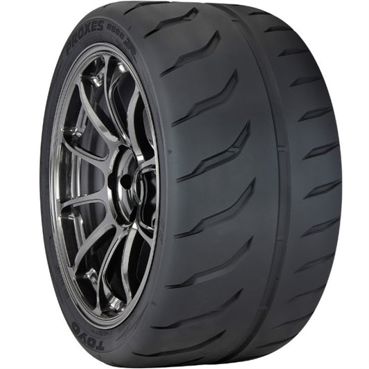 The Toyo Proxes R888R Tire, made by TOYO, features a sleek black tread with sporty alloy wheels and intricate spokes. The sidewall displays 205/55ZR16 94W, ensuring responsive handling and speed.