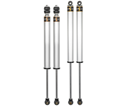 Displayed vertically against a white background, the 13-23 Ram 3500 (4WD) Commuter Shock Set features four silver automotive shock absorbers. Each absorber is designed by Carli Suspension and includes black components with a golden logo or label, making them ideal for Ram 3500 Diesel vehicles with a 3.25” lift.