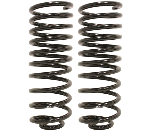 Two black metal coil springs are standing upright side by side, each featuring a helical design with evenly spaced loops. Sporting a multi-rate design, these Carli Suspension 14-23 Ram 2500 (4WD - Coil) 1" Lift Multi Rate Rear Coils are identical in size and shape, intended for use in various mechanical or automotive applications.