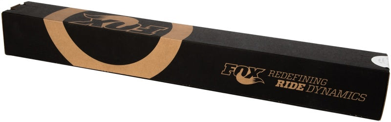 A long, black rectangular box features the text "FOX Redefining Ride Dynamics" alongside a stylized fox logo in brown. Its design showcases curved elements on the sides and top, which suggest off-road capability and a focus on performance-minded shock valving for those pursuing excellent ride dynamics. The product inside is the Fox 99+ Chevy HD 2.0 Performance Series 11.1in. Smooth Body IFP Rear Shock (Aluminum) designed for vehicles with a 4-6in. lift, from none other than FOX.