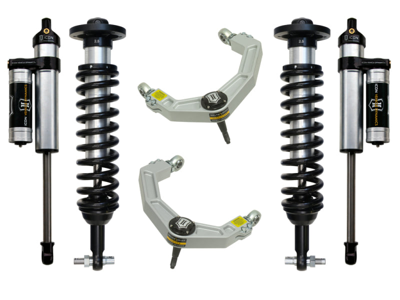 The image showcases the ICON 2014 Ford F-150 4WD 0-2.63in Stage 3 Suspension System featuring billet upper control arms. Two coilover shocks with springs, two remote reservoirs, and two Delta Joint upper control arms are arranged symmetrically on a white background for clarity and improved corrosion resistance.