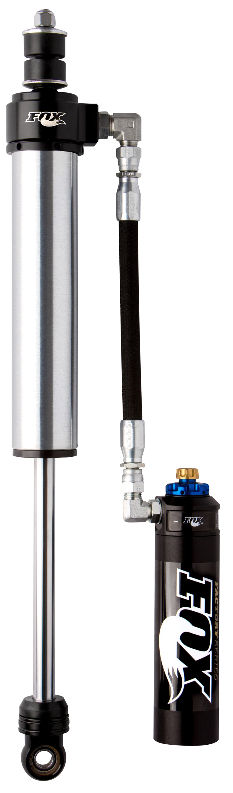 A Fox 14+ Dodge 2500 4WD Front Shock Set in silver and black, crafted from aluminum and featuring a connected hydraulic component. This 2.5 Factory Series cylindrical design displays the FOX logo on top and is equipped with a hose connected to a smaller cylinder with blue and brass fittings, showcasing the Dual Speed Compression (DSC) adjustment for vehicles lifted between 0-1.5 inches.