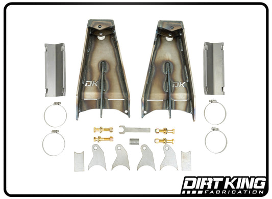 A collection of metal fabrication components and tools, featuring brackets, clamps, bolts, and a wrench, neatly organized on a white backdrop. The "DIRT KING" logo is prominently displayed in the bottom right corner, suggesting top-notch products such as the 05-23 Toyota Tacoma 6 Lug Shock Relocation Kit for improved rear suspension travel.