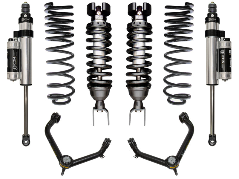 ICON 2019+ Ram 1500 2/4WD .75-2.5in Stage 5 Suspension System with Tubular UCA, by ICON, includes two coilover shocks, two additional shock absorbers, and upper control arms featuring Delta Joint technology. Displayed symmetrically against a white background, the components are metallic with contrasting black and silver accents to highlight their corrosion resistance features.