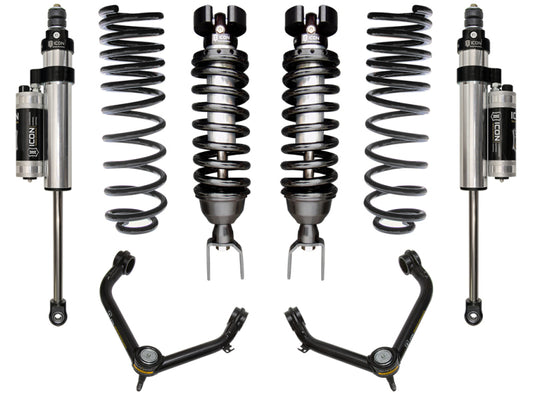 ICON 2019+ Ram 1500 2/4WD .75-2.5in Stage 5 Suspension System with Tubular UCA, by ICON, includes two coilover shocks, two additional shock absorbers, and upper control arms featuring Delta Joint technology. Displayed symmetrically against a white background, the components are metallic with contrasting black and silver accents to highlight their corrosion resistance features.