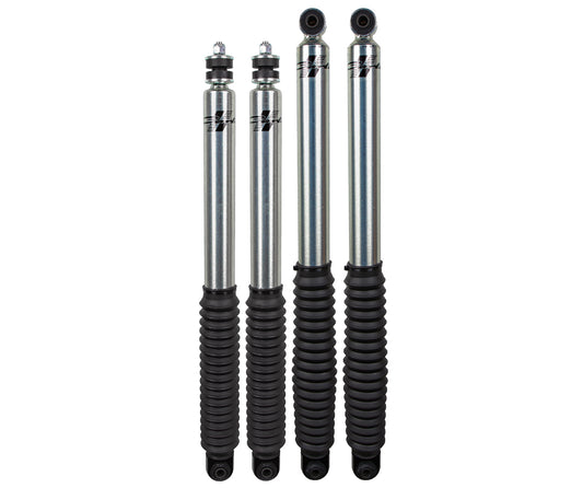 A set of four silver and black automotive shock absorbers from the Carli Suspension 05-23 Ford F-250/F-350 (4WD) CARLI SIG SERIES 2.0" IFP 2.5" LIFT SHOCK SET is arranged in a vertical alignment against a white backdrop. Each shock absorber, designed specifically for the Ford F250/F350, features a cylindrical body with black ribbed covers at the bottom, exemplifying Carli Suspension's craftsmanship.