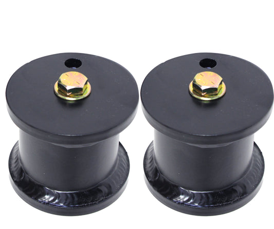 A set of black, cylindrical bump stops with gold-colored bolts on top, likely designed for mounting or support. Positioned side by side against a plain white background, these are Carli Suspension's FRONT DOMINATOR BUMP STOP DROPS made for a Ford F-250/F-350 (4WD) with a 4.5" lift.