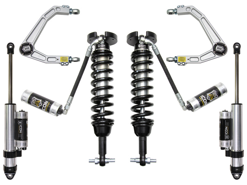 The ICON 2019+ GM 1500 1.5-3.5in Stage 4 Suspension System with Billet UCA features billet aluminum upper control arms and Delta Joint technology, and includes two coilovers and two shocks, among other components. Designed in a symmetrical black and silver color scheme with ICON brand logos, each piece features a distinct cylindrical design to enhance corrosion resistance.