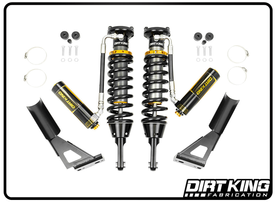 The image displays a suspension system set from DIRT KING SHOCKS, featuring the Dirt King 03-23 Toyota 4Runner 2.5 Coilovers with DCA Remote Reservoirs and mounting hardware. The components are symmetrically arranged on a white background, enhancing off-road capability.