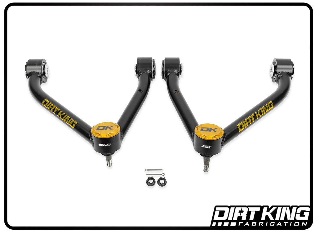 The image displays two 07-18 GM 1500 Ball Joint Tube Upper Control Arms from Dirt King, highlighted with yellow accents and labeled "Driver" and "Passenger." They come with installation hardware, including two bolts and nuts. These robust components feature heavy-duty Moog ball joints that ensure enhanced suspension geometry. The logo is located in the bottom right corner.