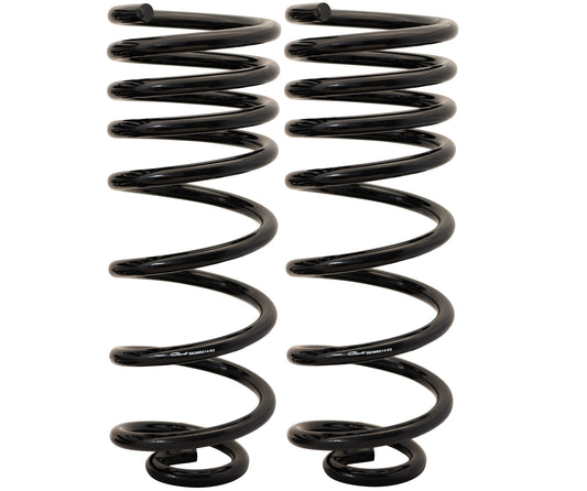 Two identical metal coil springs, designed as rear coils for a 2" lift on 14-23 Ram 2500 (4WD - Coil) vehicles, stand upright side by side on a white background. They have a shiny finish and coiled design, representing the Carli Suspension aesthetic.