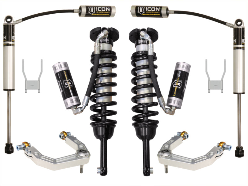 A set of suspension components from ICON, specifically the ICON 12-15 Toyota Hilux 0-3in Stage 4 Suspension System with Billet UCA, featuring remote reservoir coilover shocks, two additional shock absorbers, and two control arms. All parts are neatly arranged and displayed against a pristine white background.