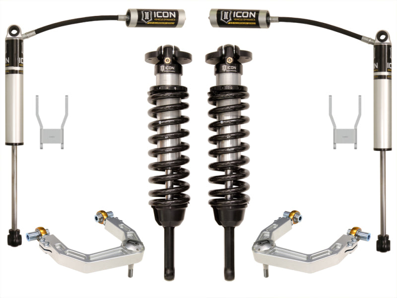 A picture showcasing the ICON 12-15 Toyota Hilux 0-3in Stage 3 Suspension System with Billet UCA from ICON Vehicle Dynamics, featuring two coilover shocks and additional components. The setup includes black springs and silver shock absorbers, specifically designed to enhance the ride of off-road vehicles. All components are displayed against a white background.