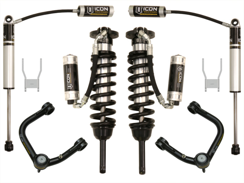 A set of ICON 12-15 Toyota Hilux 0-3in Stage 5 Suspension System with Tubular UCA, perfect for enhancing off-road performance. The set includes two coilover shocks with springs, remote reservoirs, and control arms. Displayed on a white background, these components feature a predominantly black and silver color scheme with distinctive ICON branding.