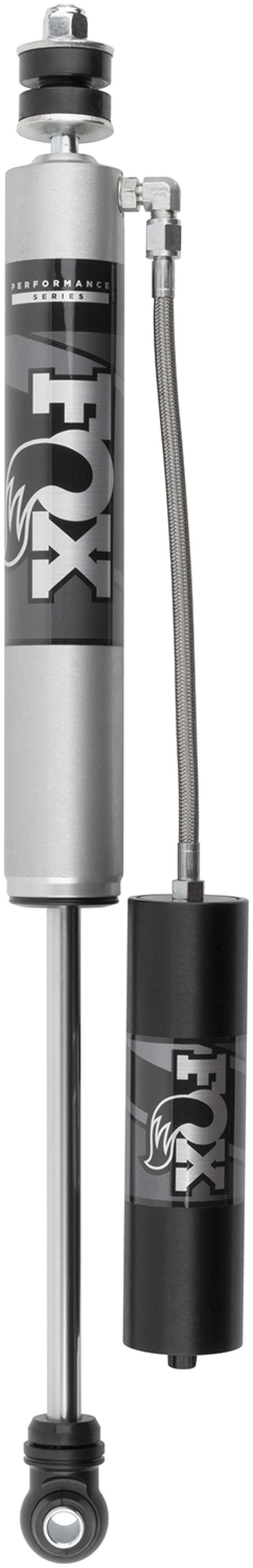 Here's an updated version of the sentence using the provided product data:

A close-up of a FOX 14-22 Dodge 2500/3500 2.0 Performance Series Front Shock Absorber in silver and black, highlighting its premium materials. It features a smooth cylindrical aluminum body connected to an external reservoir by a flexible hose, designed with performance-minded shock valving that enhances off-road capability for vehicles with a 4-6 inch lift.