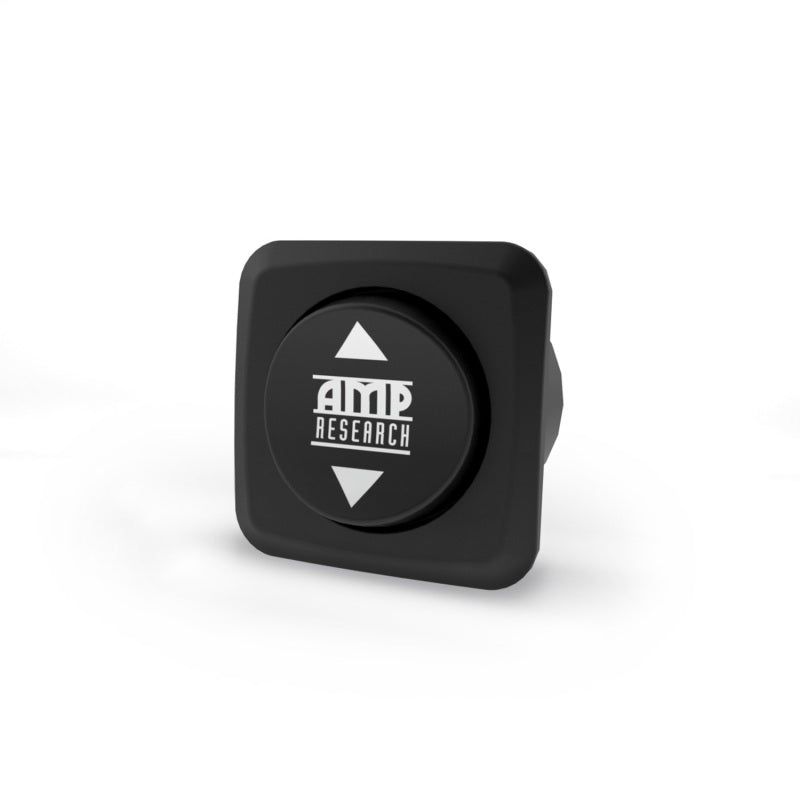 The AMP Research Override Switch features a black square design with rounded edges and the AMP Research logo at the center, complemented by two white arrows indicating activation directions for the POWERSTEP.