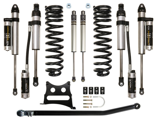 A set of suspension components, the ICON 05-16 Ford F-250/F-350 2.5in Stage 5 Suspension System, arranged neatly on a white background. The metallic parts with black accents are designed for leveling capabilities and include various hardware pieces.