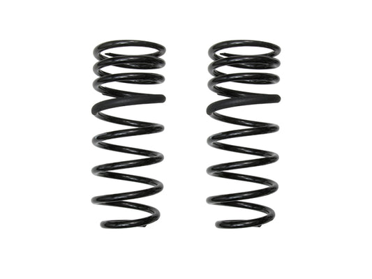 Two ICON 22-23 Toyota Tundra .5in Lift Triple Rate Rear Coil Spring Kit springs, designed by ICON for off-road performance, stand upright against a white background, aligned parallel to each other.