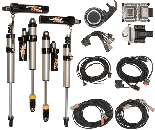 Components of automotive suspension and control systems are displayed against a white background, featuring the Carli Suspension E-Venture Shock Package. Included in this setup is the "20-23 Ford F-250/F-350 (7.3 - 4WD) GAS EVENTURE 2.5\" REMOTE RES 2.5\" LIFT SHOCK SET," complete with shock absorbers, wiring, connectors, and electronic modules.
