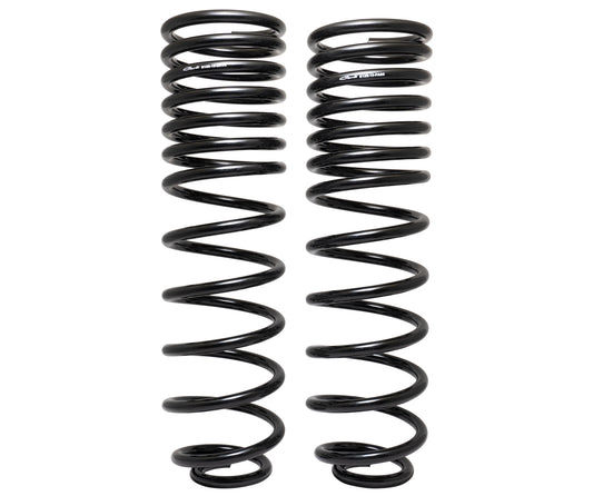 Two upright black coiled springs, designed with a multi-rate feature, stand side by side against a white background. These are from the Carli Suspension 19-23 Ram 1500 (4WD - Coil/Coil) 0.5" Lift Rear Multi Rate Coil Spring Kit.