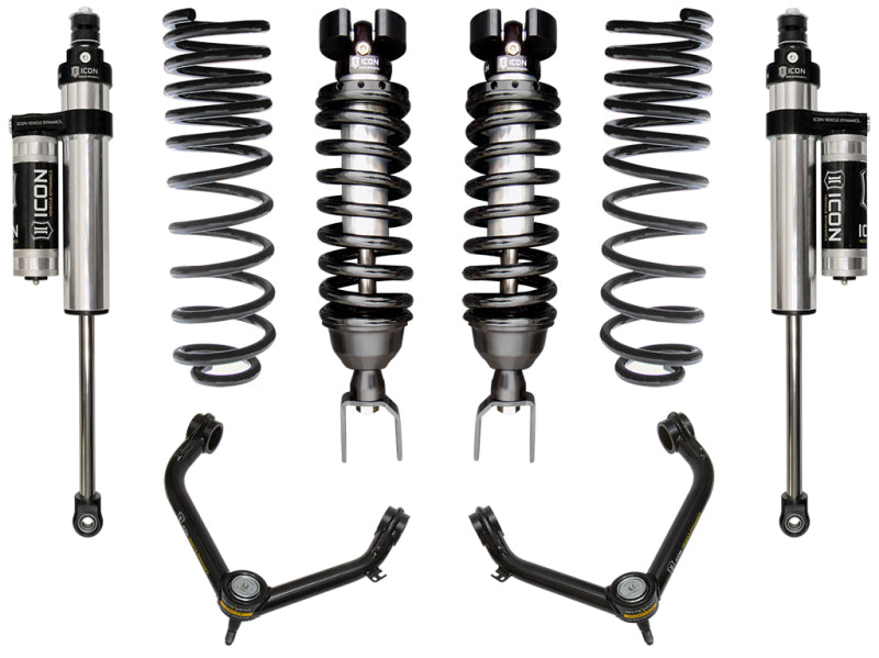 Image of the ICON 2019+ Ram 1500 2/4WD .75-2.5in Stage 4 Suspension System w/Tubular UCA, displaying two coilover shocks with springs, two additional shocks, and upper control arms with the "ICON" brand logo on the shock absorbers. These corrosion-resistant parts are symmetrically arranged on a white background.