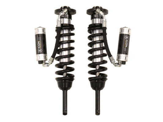 The ICON 2005+ Toyota Tacoma Ext Travel 2.5 Series Shocks VS RR CDCV Coilover Kit, featuring a 700lb spring rate, is showcased in black with silver accents and attached remote reservoirs for enhanced performance in Toyota Tacoma suspension systems.