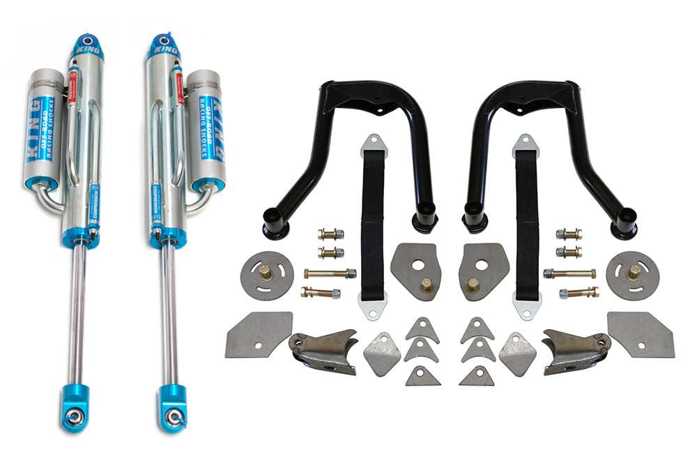 A photo of the 05-22 Toyota Tacoma Rear Shock Hoop Kit with King Bypass Shocks by TOTAL CHAOS, showcasing two blue and silver KING shock absorbers with reservoirs, two black upper control arms, and an assortment of mounting hardware and metal brackets, all neatly arranged on a white background.