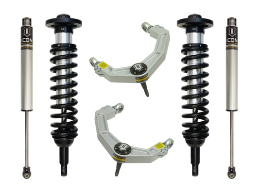 The image highlights the ICON 09-13 Ford F-150 2WD 0-2.63in Stage 2 Suspension System with Billet UCA, showcasing two expertly arranged shock absorbers with springs and two silver upper control arms featuring yellow labels, all symmetrically displayed on a white background. These parts, by the renowned brand ICON, are designed for superior corrosion resistance and enhanced durability.