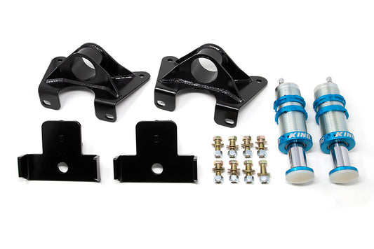 The TOTAL CHAOS Kit for 07-21 Toyota Tundra Rear Bump Stop Mounting, featuring King 2.0 Bump Stops, includes a set of vehicle suspension components such as two black steel brackets, two blue and silver shock absorbers, two smaller black mounting plates, and an assortment of bolts and nuts arranged neatly on a white background—perfect for enhancing truck handling performance.