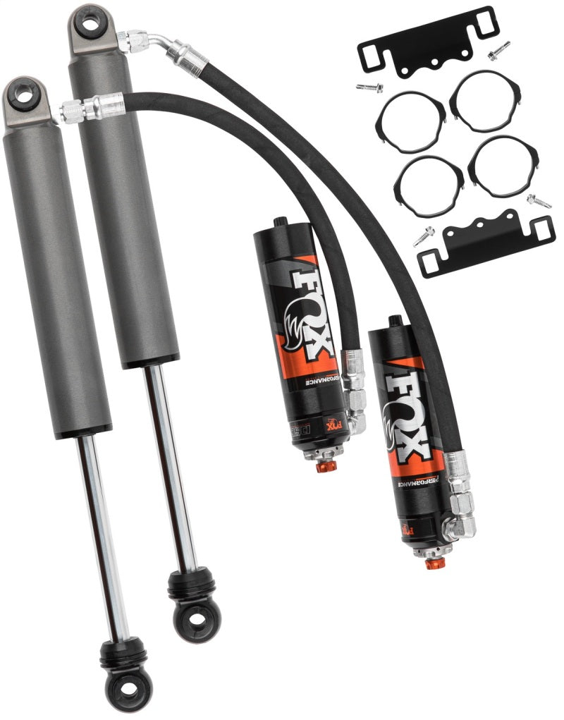 Image of FOX 19+ GM 1500 Excludes TrailBoss/AT4 0-2in Lift Rear Elite Series 2.5 Shocks w/ DSC Adj, featuring two high-performance shock absorbers with attached reservoirs, black hoses, and mounting hardware. The shocks showcase a sleek black and gray color scheme with orange accents and the iconic FOX logo, offering unparalleled adjustability for serious enthusiasts.