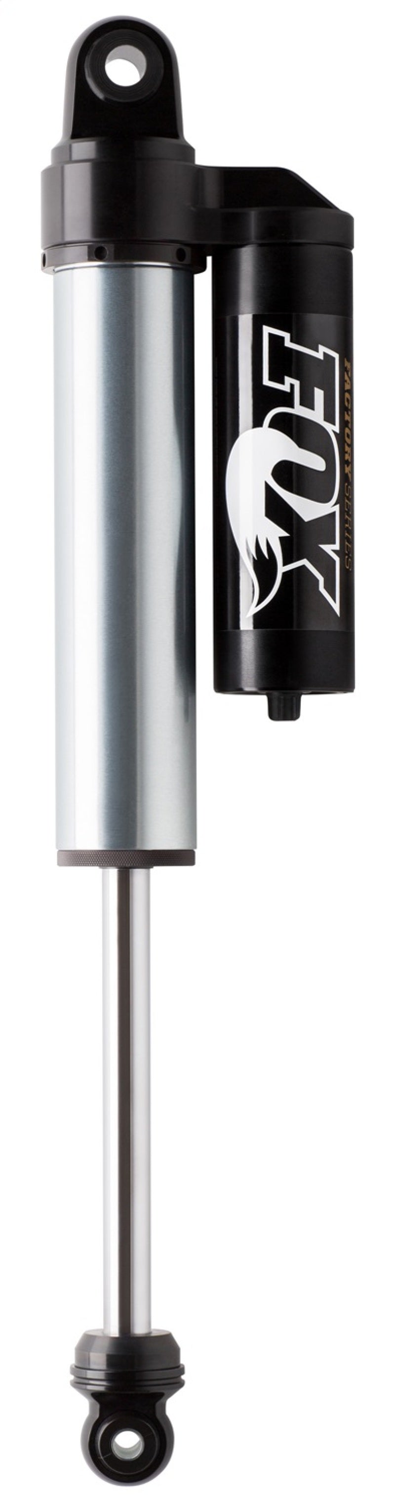 A close-up of the silver and black Fox 07+ Chevy 1500 2.5 Factory Series 9in. Piggyback Reservoir rear shock set is featured, showcasing its cylindrical components and mounting points at both ends. The FOX logo is prominently displayed, emphasizing its internal bypass technology and Dual Speed Compression adjustment for optimal performance in any ride zone.