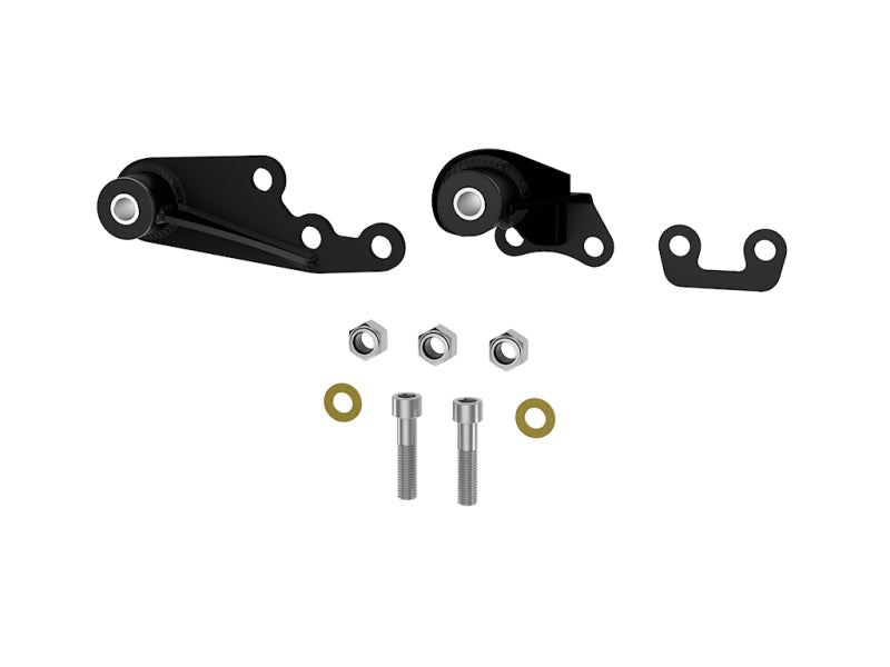 The ICON 22-23 Toyota Tundra Diff Drop Kit by ICON includes a pair of black metal brackets with attached cylindrical components, polyurethane mounting bushings, and is completed with two bolts, two washers, and two nuts. This crucial kit is designed to correct CV angles, and it is displayed neatly on a white background.