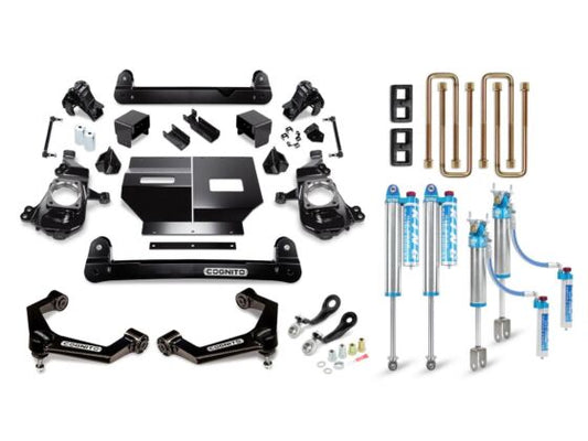 The Cognito 4-Inch Elite Lift Kit with King 2.5 Reservoir Shocks for the 20-24 Silverado/Sierra 2500/3500 2WD/4WD includes a range of vehicle suspension components such as upper control arms, a Pitman and Idler Arm Support Kit, shock absorbers, brackets, and hardware. These parts are neatly organized and labeled under the "Cognito Motorsports" brand against a plain white background.