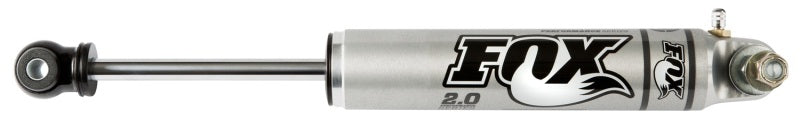 The FOX 05-07 Ford SD 2.0 Performance Series steering stabilizer, made of aluminum with a smooth body and silver finish, features adjustable damping and advanced shock valving to enhance off-road capability, improving ride quality and stability for superior performance.