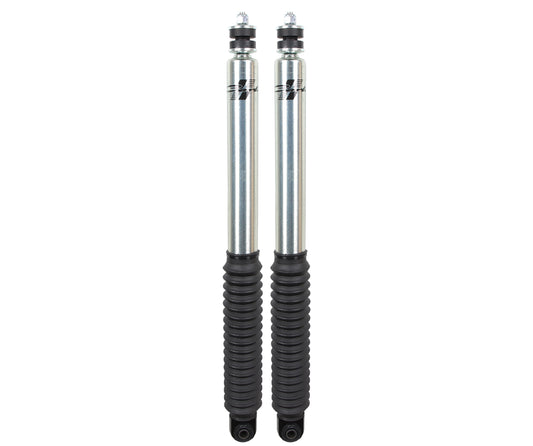 Two Signature Series 2.0 Front Shocks for a 94-13 Dodge Ram 2500/3500 (4WD), designed for a 2.75" lift by Carli Suspension, with silver bodies and black rubber boots, are positioned vertically against a white background, showcasing the precision engineering of the Dodge Signature Series.