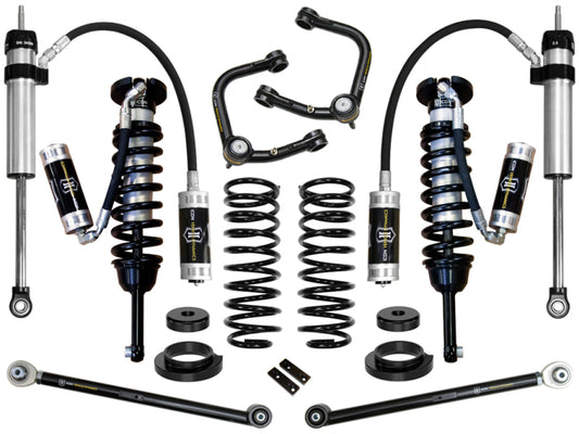 The ICON 03-09 Lexus GX470 0-3.5in Stage 5 Suspension System with Tubular UCA is displayed against a white background, showcasing corrosion-resistant shock absorbers, coil springs, and upper control arms incorporating Delta Joint technology.