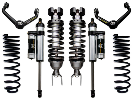 Image showcasing the ICON 09-18 Ram 1500 4WD .75-2.5in Stage 4 Suspension System, with neatly arranged components including two coilover shocks, springs, shock absorbers, and upper control arms. The parts feature a primarily black and silver color scheme with branded labels from ICON.