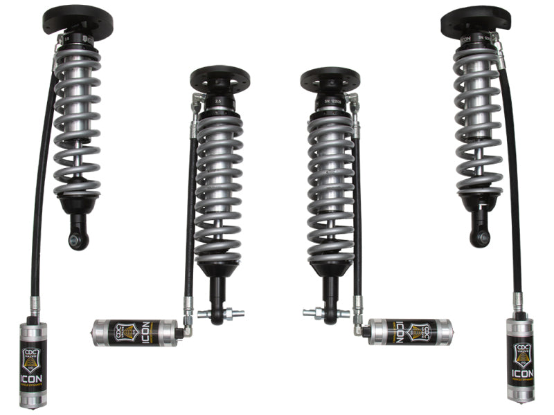 The image highlights the ICON 2014+ Ford Expedition 4WD .75-2.25in Stage 1 Suspension System, featuring four coilover shocks with external reservoirs, designed for off-road adventures. These metallic coil springs, boasting black and silver components, are ideal for enhancing the rugged appeal of a Ford Expedition.