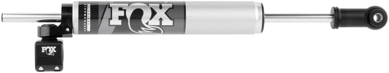 The Fox 08-16 Ford Superduty 2.0 Performance Series 8.2in. TS Stabilizer Bottom Axle Mount, featuring a sleek silver finish with a black connector and cap on one end, is engineered for off-road excellence. The FOX logo stands out in bold white, reflecting its performance-driven shock valving that ensures superior handling and stability.
