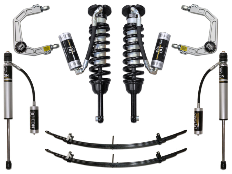 The ICON 05-15 Toyota Tacoma Stg 4 Suspension System, incorporating advanced Delta Joint technology, includes two coilover shocks, billet upper control arms, leaf springs, and additional shock absorbers symmetrically displayed on a white background.