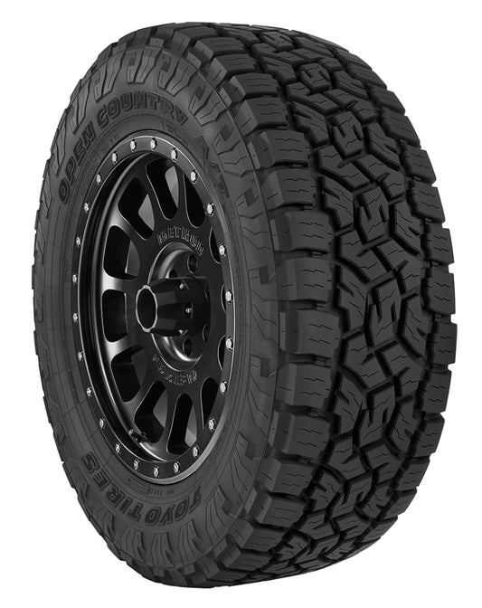 A tough Toyo Open Country A/T III Tire in size 35X1250R18, featuring deep treads and a black alloy wheel. The sidewall bears the labels "Open Country" and "Toyo Tires." Its aggressive tread patterns deliver improved traction on challenging terrain.