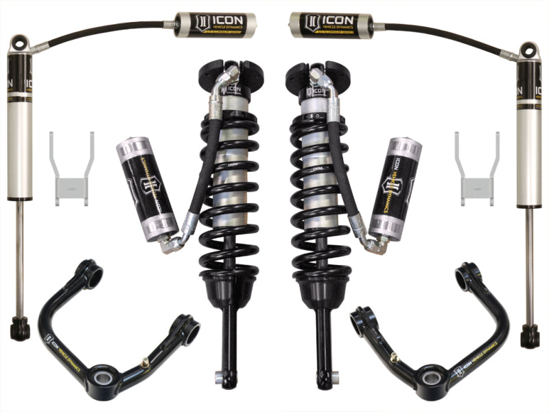 Components of the suspension system, like the remote reservoir coilover shocks and control arms for the Toyota Hilux, are symmetrically arranged. The shock absorbers with coil springs prominently display the brand label "ICON.