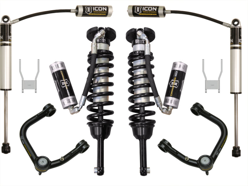 Photograph showcasing the ICON 05-11 Toyota Hilux 0-3in Stage 4 Suspension System w/Tubular UCA from ICON, highlighting its off-road performance enhancements such as remote reservoir coilover shocks, upper control arms, and brackets. The components are symmetrically arranged on a white background.