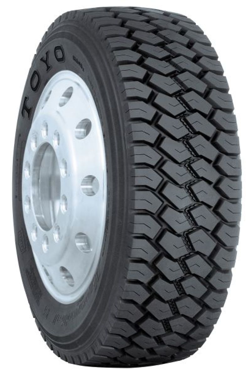 A close-up image features the Toyo M608Z truck tire, sized 265/70R195, with rugged treads for heavy-duty vehicles. The tire is mounted on a silver metallic rim, and the "TOYO" brand is prominently displayed on the sidewall.