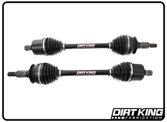 Two black 19-25 GM 1500 Long Travel Axle Assemblies with the "DIRT KING" logo in the center, designed for a Silverado 1500, are displayed horizontally on a white background. Each assembly features ribbed rubber boots on both ends. The "DIRT KING FABRICATION" logo is positioned in the bottom right corner, highlighting its long travel axle capabilities.