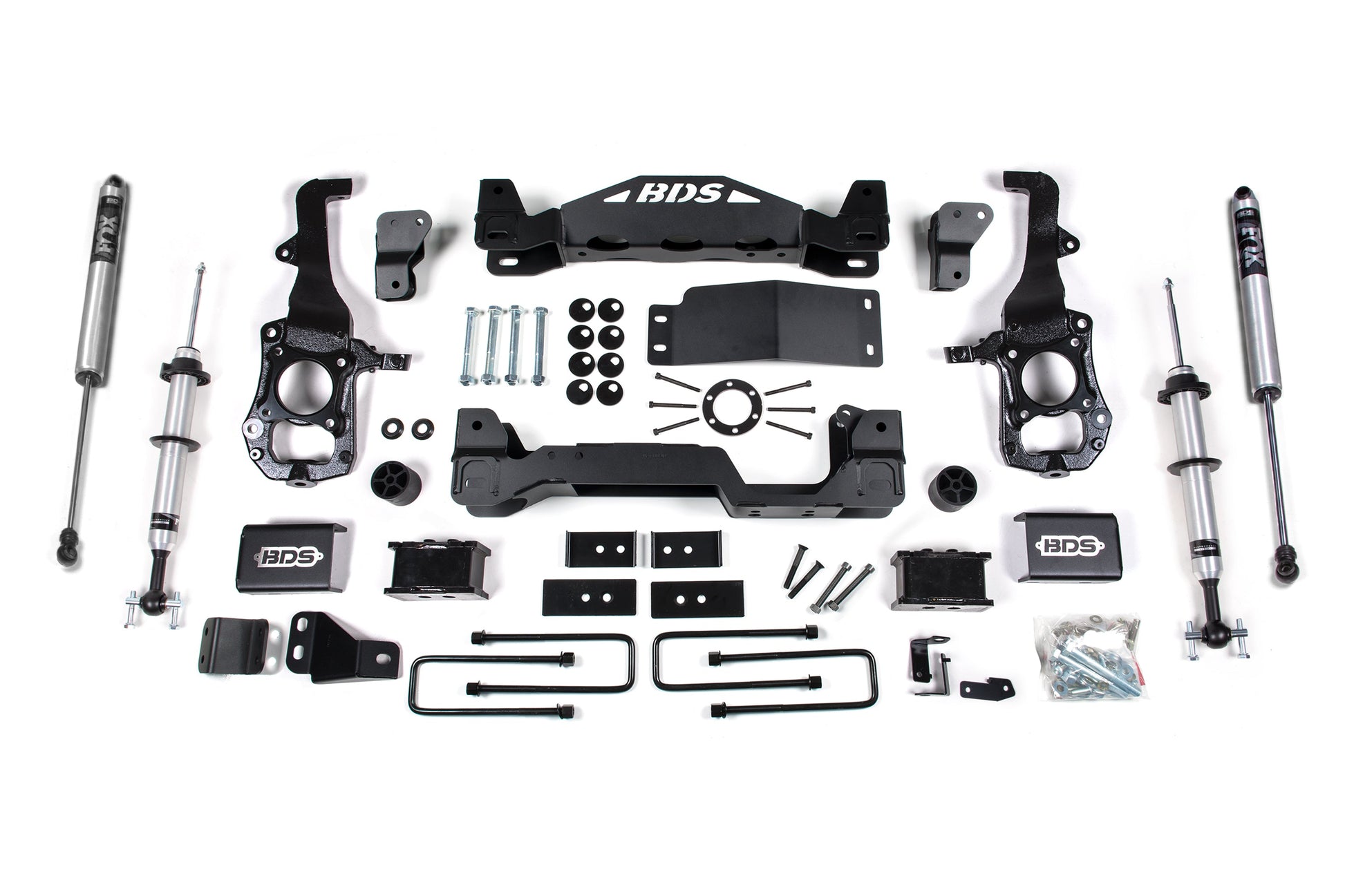 A complete BDS 4 Inch Lift Kit with FOX 2.0 struts for a Ford F150 (2021-2023) 4WD, including coil springs, shocks, brackets, bolts, nuts, and other components is laid out on a white background. The components are neatly arranged and labeled with the BDS logo visible on several parts.