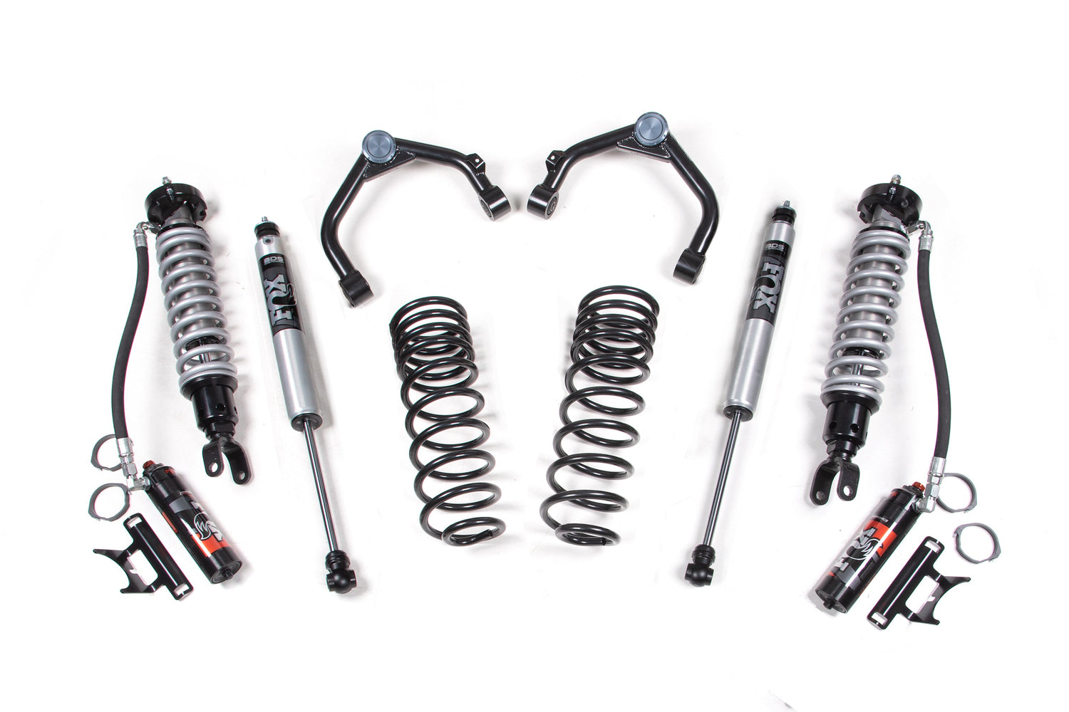 The 3 Inch Lift Kit by BDS, featuring FOX 2.5 Performance Elite Coil-Over shocks, coil springs, and control arms for the Ram 1500 (19-23) 4WD, is arranged symmetrically. The components are metallic with black and silver finishes; some include hoses and adjustment hardware.