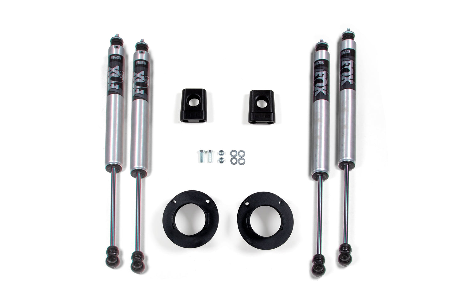 Four FOX 2.0 shocks, two mounting brackets, and additional hardware including screws, nuts, and circular rubber components are arranged neatly on a plain white background. Perfect for the BDS 2 Inch Leveling Kit for Ram 3500 (13-22) 4WD.