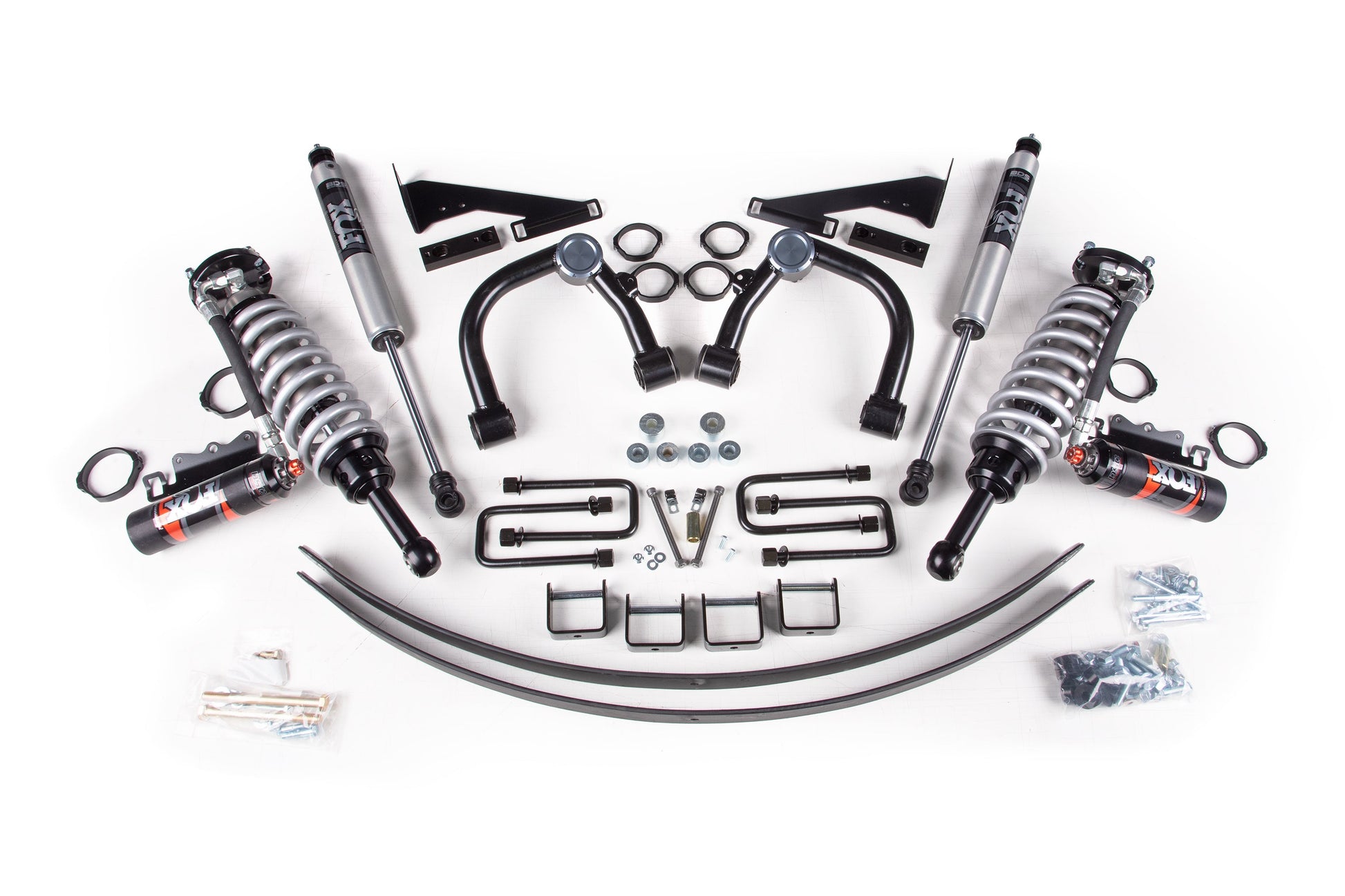 A variety of automotive suspension components from the BDS 3 Inch Lift Kit with FOX 2.5 Coil-Over for Toyota Tacoma (05-15) 4WD—including coilover shocks, upper control arms, leaf springs, and various mounting hardware such as bolts, washers, U-bolts, and brackets—are neatly organized and displayed on a white background.